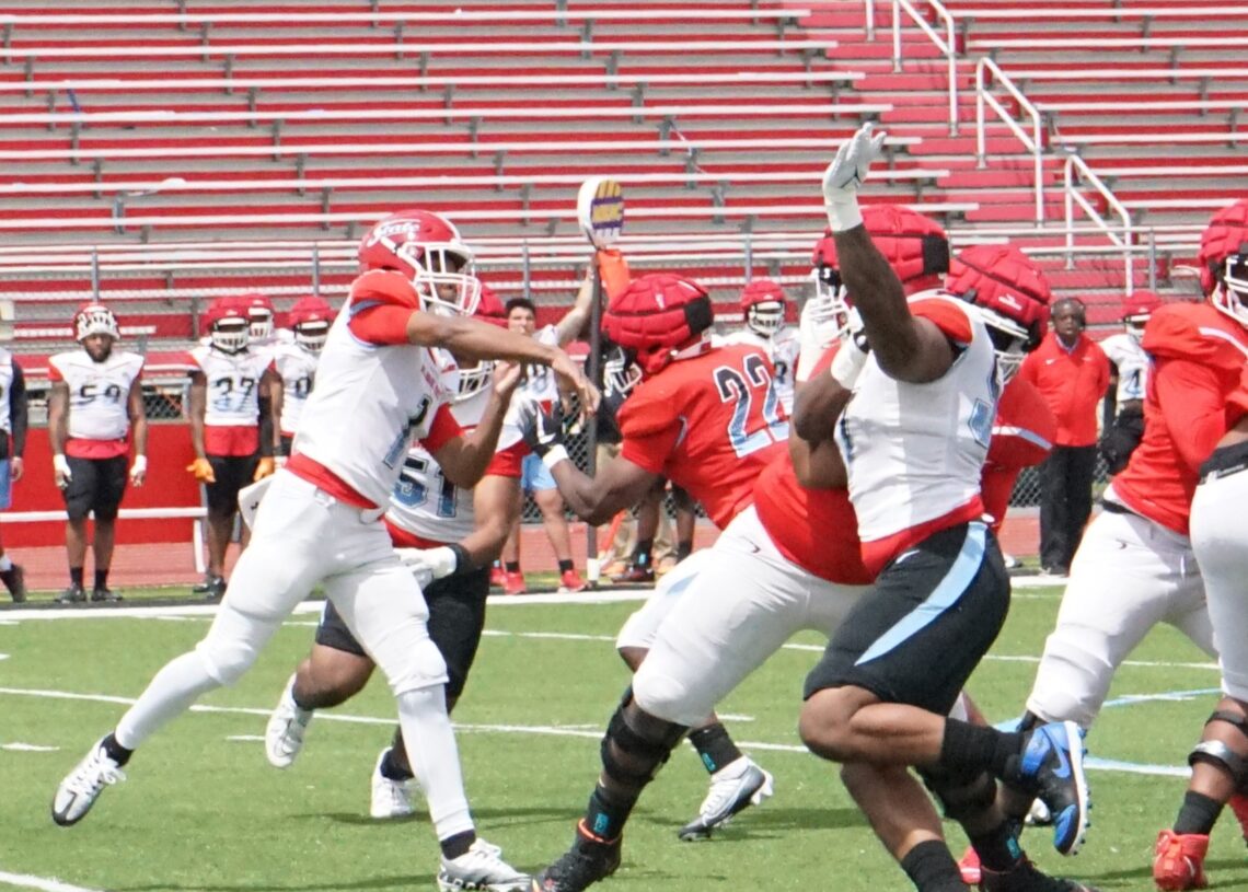 Delaware State quarterback Marqui Adams gets a throw away under pressure from defensive lineman Kyle Williams. Chris Stevens/HBCU Sports